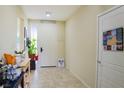 Bright hallway with tile flooring, complemented by décor and a view to the front of the home at 4914 E Beacon Ridge Dr, Pahrump, NV 89061