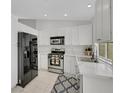 Bright kitchen with modern stainless steel appliances and white cabinetry at 523 Rancho Del Norte Dr, North Las Vegas, NV 89031