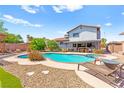 Private backyard pool and spa with lounge area, perfect for entertaining at 5361 Cabrito Dr, Las Vegas, NV 89103