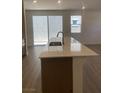 Modern kitchen featuring a large island with a sink and stylish countertops at 6574 Tumoulin St, Las Vegas, NV 89148