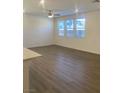 Spacious living room with hardwood floors, a ceiling fan, and plenty of natural light at 6574 Tumoulin St, Las Vegas, NV 89148