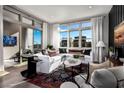 Stylish living area bathed in natural light, featuring sleek furniture, hardwood floors, and scenic views at 664 Agate Bridge St, Las Vegas, NV 89138