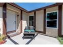 Inviting front porch featuring a cozy seating area and charming home number at 681 Pine Ridge Dr, Las Vegas, NV 89110