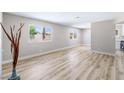 Bright and spacious living room with modern wood-style flooring and large windows at 681 Pine Ridge Dr, Las Vegas, NV 89110