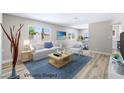 Staged living room with elegant furniture, decor, and lots of natural light at 681 Pine Ridge Dr, Las Vegas, NV 89110