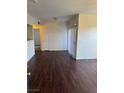 Spacious living room features hardwood floors, sliding glass door, and neutral paint at 6955 N Durango Dr # 1038, Las Vegas, NV 89149