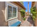 Charming exterior with a bench, window with shutters, and landscaped walkway to the front door at 7473 Crystal Clear Ave, Las Vegas, NV 89113