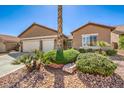 Well-maintained home with a three-car garage and low-maintenance desert landscaping at 7473 Crystal Clear Ave, Las Vegas, NV 89113