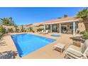 Sparkling pool and spa with an outdoor seating area, perfect for relaxing and entertaining at 7473 Crystal Clear Ave, Las Vegas, NV 89113