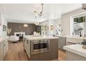 Open concept kitchen featuring an island with a microwave and a view of the living room at 7825 Desert Bell Ave, Las Vegas, NV 89128