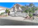 Charming single-Gathering home featuring a well-maintained yard, tile roof, and an attached two-car garage at 8052 Marbella Cir, Las Vegas, NV 89128