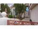 Front entrance adorned with mature landscaping, offering privacy and curb appeal at 8052 Marbella Cir, Las Vegas, NV 89128