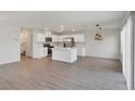 Spacious living area and kitchen boasts sleek floors and contemporary lighting fixtures at 816 Sand Camel Ct, North Las Vegas, NV 89081
