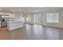 Bright, open-concept living space features wood floors, modern lighting, and access to backyard at 816 Sand Camel Ct, North Las Vegas, NV 89081