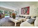 Inviting living room with plush seating, a stylish coffee table, and views of the outdoor pool at 940 Vegas Valley Dr, Las Vegas, NV 89109