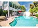 Backyard oasis with a sparkling pool, cozy seating area, and lush greenery for ultimate relaxation at 940 Vegas Valley Dr, Las Vegas, NV 89109