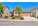 Cozy single-story home with a tile roof, desert landscaping, and attached two-car garage at 9588 Comiskey Ct, Las Vegas, NV 89148