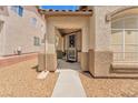 Inviting front entryway with a decorative security door, textured stucco walls and desert landscaping at 9588 Comiskey Ct, Las Vegas, NV 89148