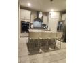 Bright kitchen featuring stainless steel appliances, granite countertops, pendant lighting, and a center island at 11815 Corenzio Ave, Las Vegas, NV 89138