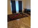 Room with a home gym and a pool table on wood-look flooring with a window dressed in dark curtains at 11815 Corenzio Ave, Las Vegas, NV 89138