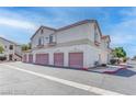 Condos with garages feature cream stucco, red roof tiles, and individual garages at 1300 S Arlington St # 202, Las Vegas, NV 89104