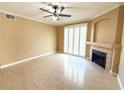 A spacious living room boasts wood floors, a ceiling fan, and a cozy fireplace at 1300 S Arlington St # 202, Las Vegas, NV 89104