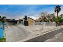 Inviting property with a carport, eye-catching chimney feature, and fenced yard for added privacy and charm at 1708 Poplar Ave, Las Vegas, NV 89101