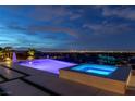 Inviting pool and spa with city views at night at 2 Olympia Outlook Dr, Las Vegas, NV 89141