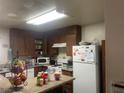 Functional kitchen featuring wood cabinetry and standard appliances at 2574 Paradise Village Way, Las Vegas, NV 89120