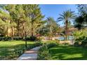 Landscaped Meridian community with a walkway through the lawn leading to the community pool at 270 E Flamingo Rd # 214, Las Vegas, NV 89169