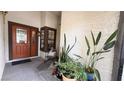 Inviting front entrance featuring a decorative glass door, sconce lighting, and charming outdoor decor at 2701 Brookstone Ct, Las Vegas, NV 89117