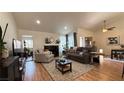 Spacious living area featuring a fireplace, comfortable seating, hardwood floors, and contemporary decor at 2701 Brookstone Ct, Las Vegas, NV 89117