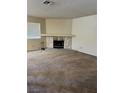 Neutral living room with carpet, a stone fireplace, and a large window at 2713 Otter Creek Ct # 202, Las Vegas, NV 89117