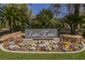 Welcoming entrance to Lakes Estates, featuring lush landscaping and a community sign at 2805 High Sail Ct, Las Vegas, NV 89117