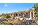 Relaxing covered patio with stone pillars and a water feature, perfect for outdoor living at 2864 Sumter Valley Cir, Henderson, NV 89052