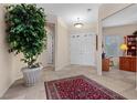 Welcoming entryway featuring tile flooring and a large potted tree at 2864 Sumter Valley Cir, Henderson, NV 89052