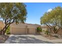 Charming home with a three-car garage, manicured landscaping and mature shade trees at 2864 Sumter Valley Cir, Henderson, NV 89052