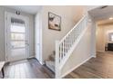 Bright entryway features wood-look flooring and a staircase with white railing at 356 Silva Pl, Henderson, NV 89011