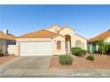 Single-story home showcasing a neat front yard, an attached garage, and a red tile roof at 3854 Spruceview Ct, Las Vegas, NV 89147