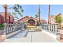 Clubhouse entrance with a red tile roof, a concrete courtyard, and double doors at 4050 Pacific Harbors Dr # 107, Las Vegas, NV 89121