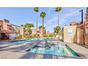 Community pool and spa area with lounge chairs and palm trees for relaxing outdoors at 4050 Pacific Harbors Dr # 107, Las Vegas, NV 89121