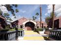 Mediterranean-style community center with arched entryway, stone accents, and manicured landscaping at 4050 Pacific Harbors Dr # 245, Las Vegas, NV 89121