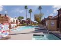 Community pool with a hot tub, chaise lounges, and mature landscaping at 4050 Pacific Harbors Dr # 245, Las Vegas, NV 89121