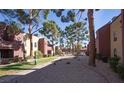 Exterior of community with mature trees, green grass and manicured landscaping at 4050 Pacific Harbors Dr # 245, Las Vegas, NV 89121