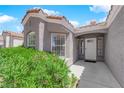 Close up of the front entrance of the home with tidy landscaping at 4244 Totano Dr, North Las Vegas, NV 89032