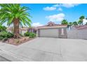 Charming single story home with desert landscaping, palm trees, and a two car garage at 4244 Totano Dr, North Las Vegas, NV 89032