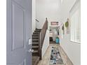 Bright entryway with wood flooring, staircase, 