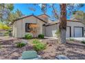 Inviting single-story home with a desert landscape and neutral stucco exterior at 4905 Ocean Shores Way, Las Vegas, NV 89130