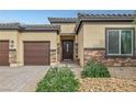 Attractive front entrance featuring a brick driveway, landscaping, and a charming front door at 5234 Savannah Rose St, Las Vegas, NV 89149