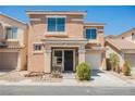 Two-story home showcasing neutral stucco facade, covered porch entry, manicured landscaping, and attached garage at 5439 Bradford Pear Dr, Las Vegas, NV 89122